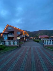 a house on a brick road with a fence at Vivat in Solochyn