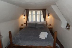 a bedroom with a large bed in a attic at Casa Plaiul Cailor: Rustic Mountain Hideaway in Proviţa de Sus