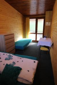 a room with a bed and a table in a room at Chata Alenka in Štítary