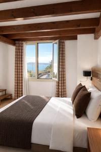 a bedroom with a large bed with a large window at Hotel Miramar in Cap d'Ail +62 photos