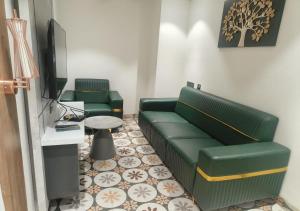 a living room with a couch and a tv at K R GRAND in Vijayawāda