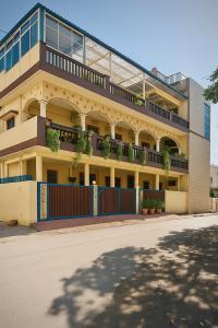 an apartment building with a fence and plants on it at Hidden Leaf in Dehradun