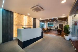an office lobby with a white counter and a table at New Prestige Hotel in Hyderabad