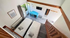 an overhead view of a room with a bed and a table at Logis Hôtel La Demeure du Perron in Quettehou