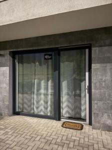 a glass door of a building with a sign on it at ILK Residence in Balatonalmádi
