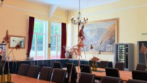 a conference room with a large painting on the wall at Hotel Blüchertal in Bacharach