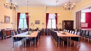 a dining room with tables and chairs and windows at Hotel Blüchertal in Bacharach