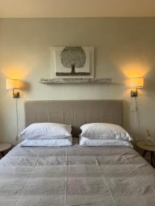 a bedroom with a large bed with two pillows at L'appart des lutins in Pornic