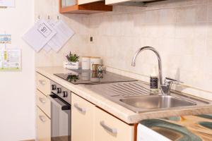 a kitchen with a sink and a counter top at Casa Nel Blu in SantʼAlessio Siculo