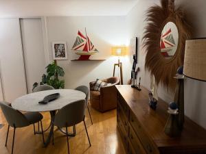 a living room with a table and chairs in it at L'appart des lutins in Pornic