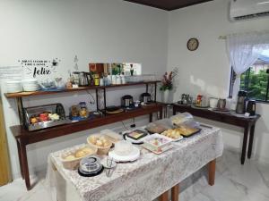 a table with a buffet of food on it at Hotel Maringá in Juara