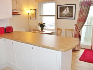 a kitchen with a wooden counter top in a room at Watch House in Fowey +12 photos