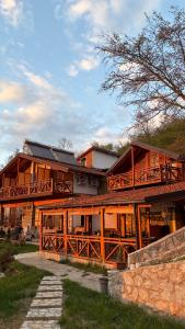 a large wooden house with a large deck at Sunset House in Ohrid