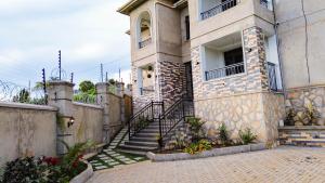 a building with stairs in front of it at The apartments-Bwebajja in Bwebajja