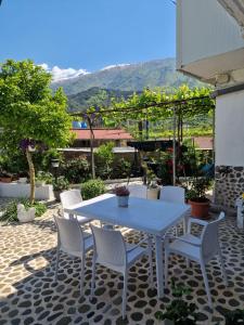 a white table and chairs on a patio at Guest House KrisHen in Përmet