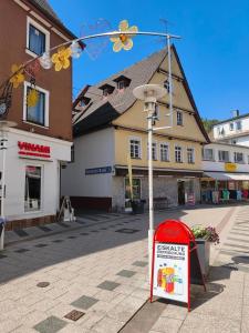 a street sign and a street light in a town at Vinami Hotel - Bad Wildbad in Bad Wildbad