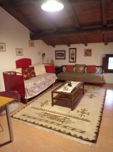 a living room with a couch and a coffee table at Dulcius ex Asperis Bed & breakfast in Ponte Nizza