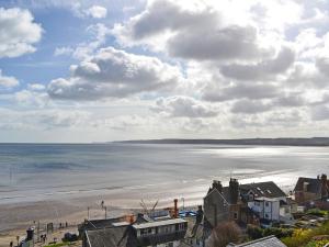 a view of a beach with houses and the ocean at Beech - Uk47622 in Hunmanby