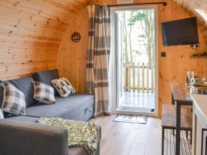 a living room with a couch and a large window at Beech - Uk47622 in Hunmanby