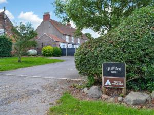 a sign in front of a house with a driveway at Beech - Uk47622 in Hunmanby