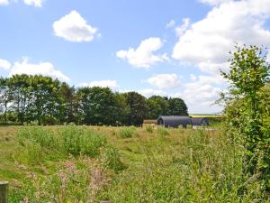 a barn in the middle of a field at Beech - Uk47622 in Hunmanby