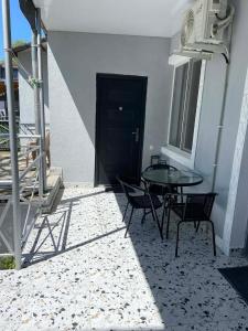 a patio with a table and chairs in front of a building at Andre in Kutaisi