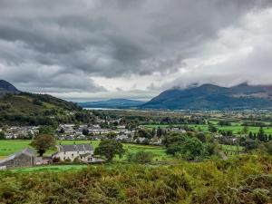 a small town in a valley with mountains in the background at Causey Pike in Keswick