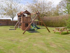a playground with a slide and a picnic table at Eldin Hall Cottage 1 - Uk2483 in Cayton