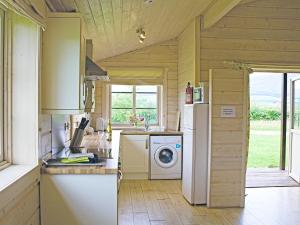 a kitchen with a refrigerator and a washing machine at Skylark Lodge - Uk51678 in Carsethorn