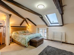 a bedroom with a large bed and a skylight at Orchard Cottage - Uk30437 in Kingsbury Episcopi