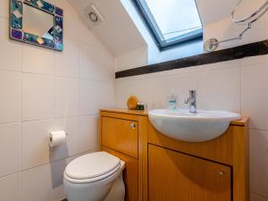 a bathroom with a sink and a toilet and a window at Orchard Cottage - Uk30437 in Kingsbury Episcopi
