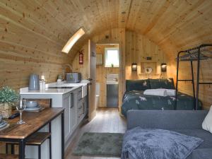 a room with a bed and a kitchen in a cabin at Sycamore - Uk47621 in Hunmanby +9 photos
