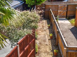 a garden with a fence and some plants at Riverside in March