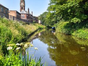 a river with a clock tower in the background at Riverside in March