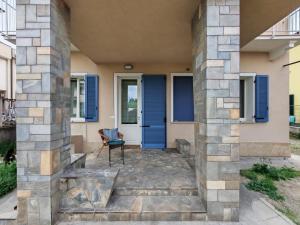 a house with a blue door and a chair at San bernardo guest house in Fossano