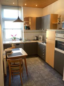 a kitchen with a small table and a table and chairs at Ruhrpott Liebe in Herten