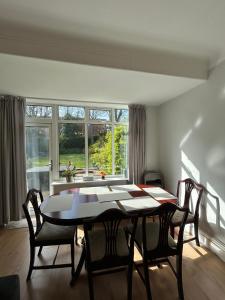 a dining room with a table and chairs and a window at Bella Beach House in Whitley Bay