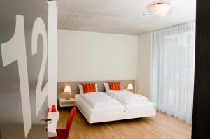 a bedroom with a white bed and a window at Gästehaus Hunziker in Zurich