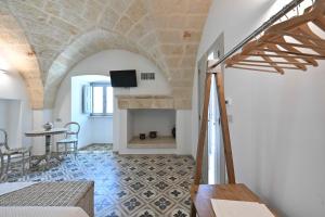 a living room with a table and a fireplace at Corte di Torre Spaccata in Torre Canne