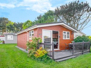 a small house with a deck in a yard at Skylarks in Saint Merryn