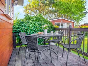 a table and chairs on a wooden deck at Skylarks in Saint Merryn