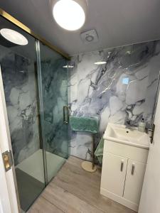 a bathroom with a shower and a sink at Bella Beach House in Whitley Bay +56 photos