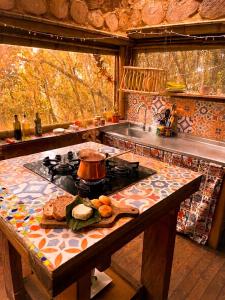 a kitchen with a stove and a counter top at Bosque Hondo Ecoliving in Medellín