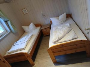 two bunk beds in a small room with a window at Seeschwalbe 11 in Mirow