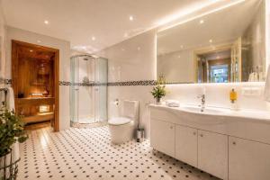 a bathroom with a toilet and a sink and a shower at Tallinn Residence 1937 in Tallinn +28 photos