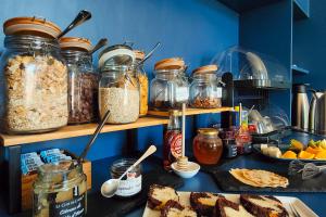a kitchen counter with jars of food and other ingredients at Aparthotel AMMI Nice Massena in Nice