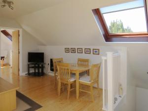 a dining room with a table and chairs and a window at Elm Loft in Upton +5 photos