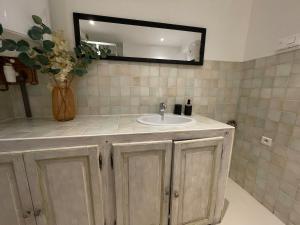 a bathroom with a sink and a mirror at Studio in Fayence