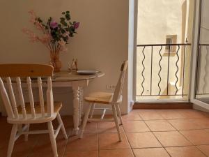 a table and chairs in a room with a balcony at Studio in Fayence +2 photos