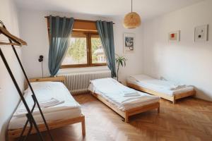 a room with two beds and a window at Kmetija Pečnik in Prevalje